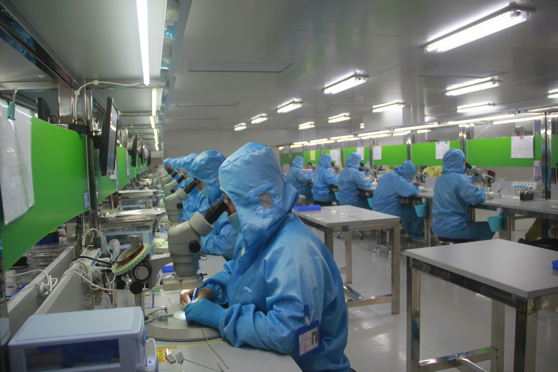 Pharmaceutical cleanroom technicians in protective gear
